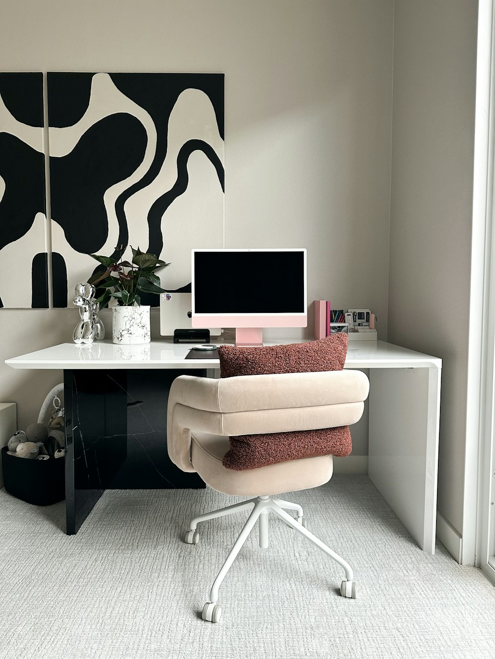 a desk with a computer and a chair