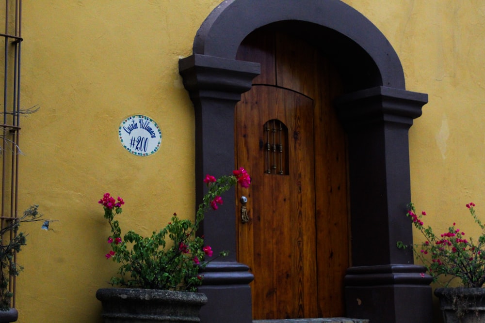 a yellow building with a brown wooden door