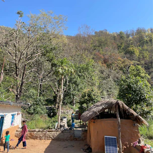 A vibrant community gathering around a newly built solar-powered water well in a rural village.