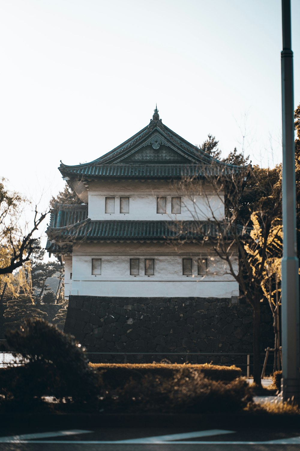 a tall white building sitting on the side of a road