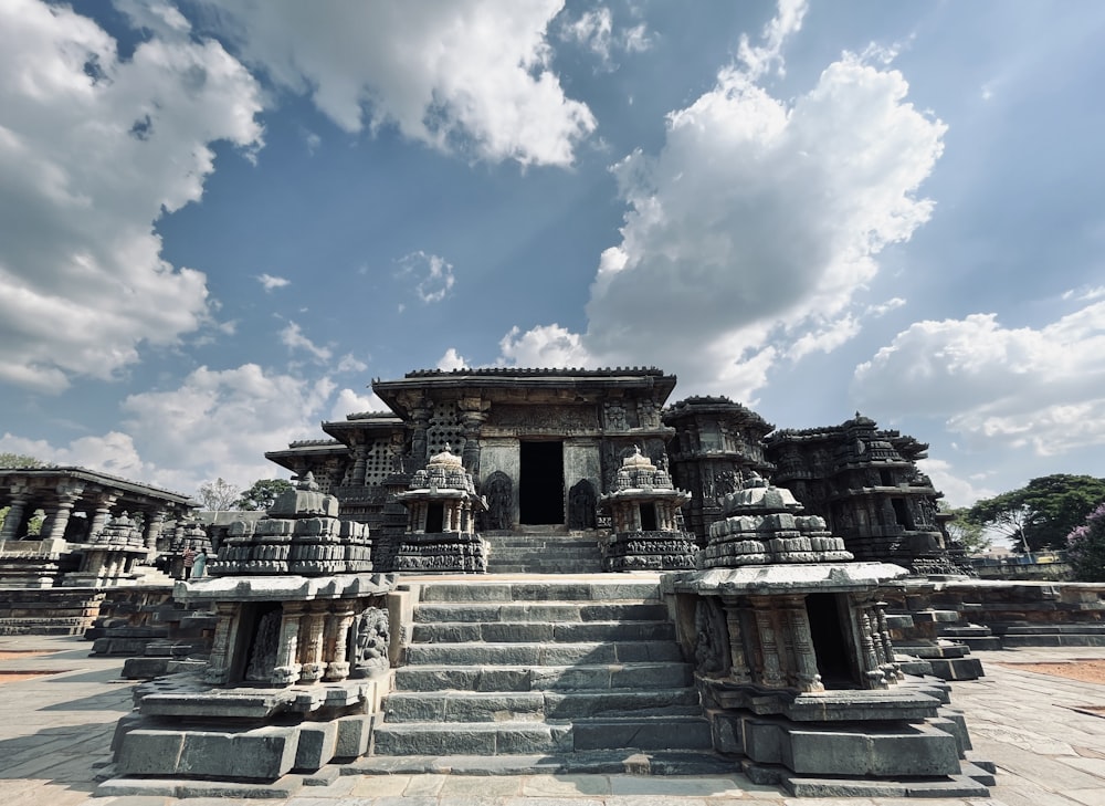 a group of statues sitting on top of a stone walkway