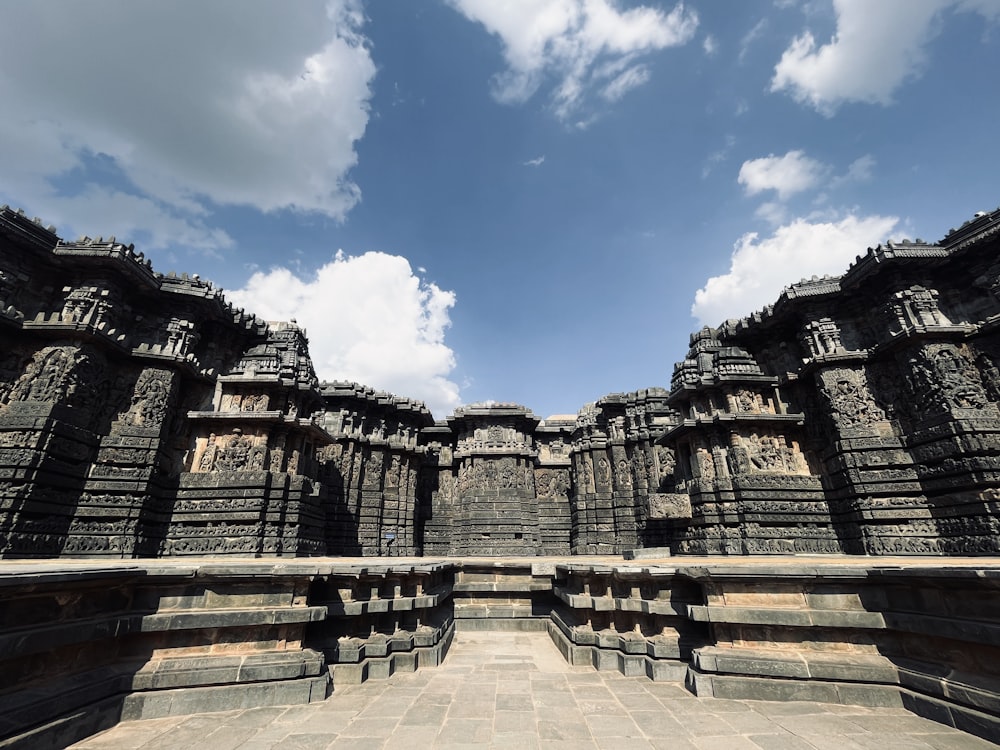 a large stone structure with a sky in the background