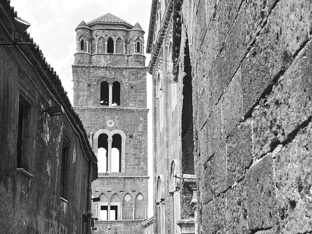 a black and white photo of a narrow street