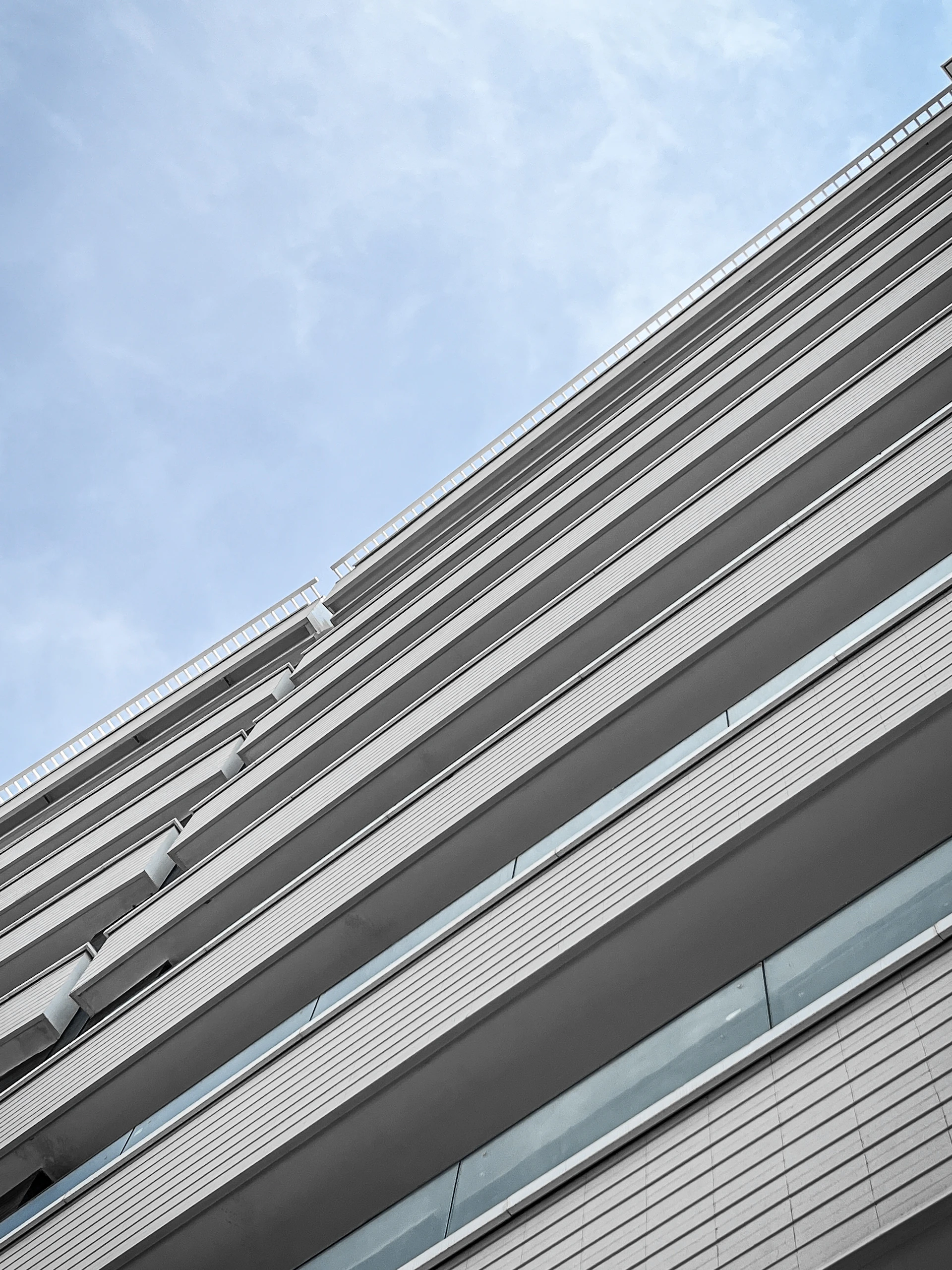 A dynamic 3D animation still of a luxury real estate project exterior, highlighting intricate architectural details against a clear blue sky.