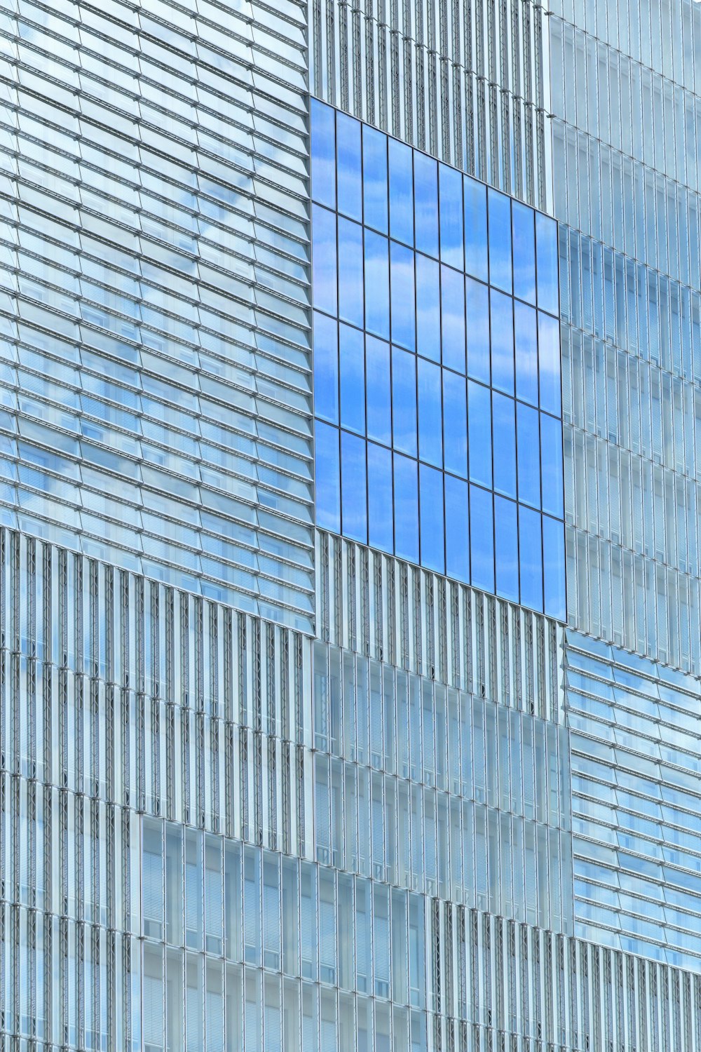 a plane flying in front of a very tall building