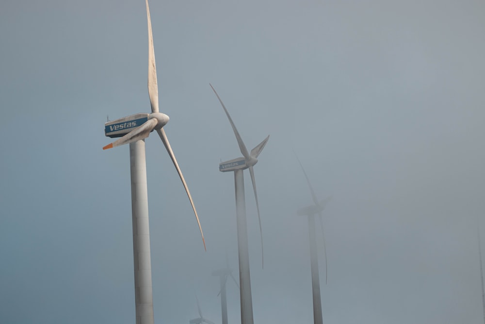 a bunch of windmills that are in the fog