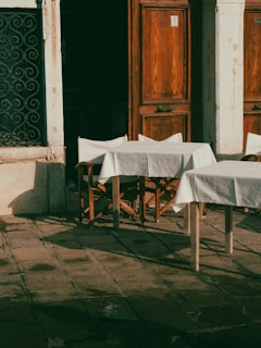 An outdoor café scene featuring a model in a chic outfit with natural lighting.