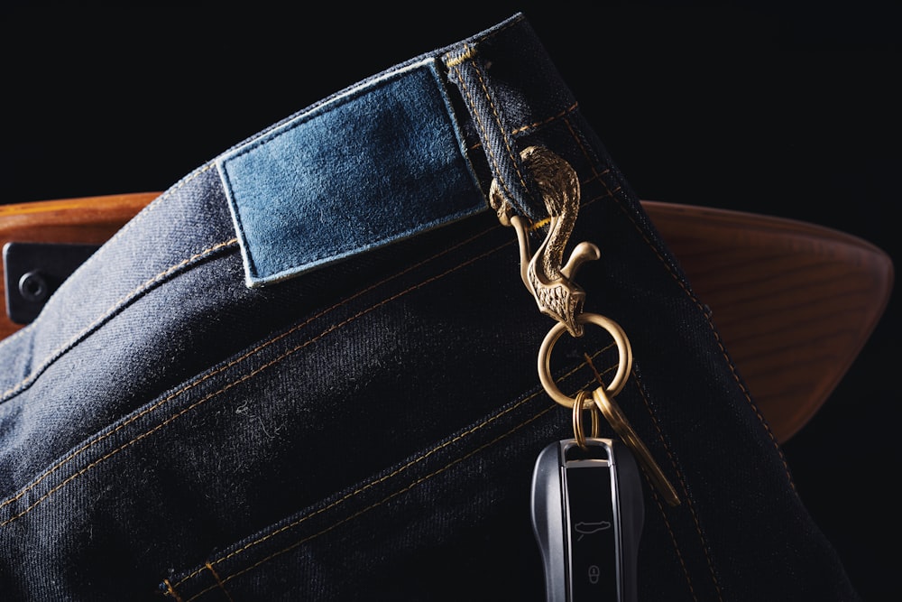 a pair of jeans with a metal keychain attached to it