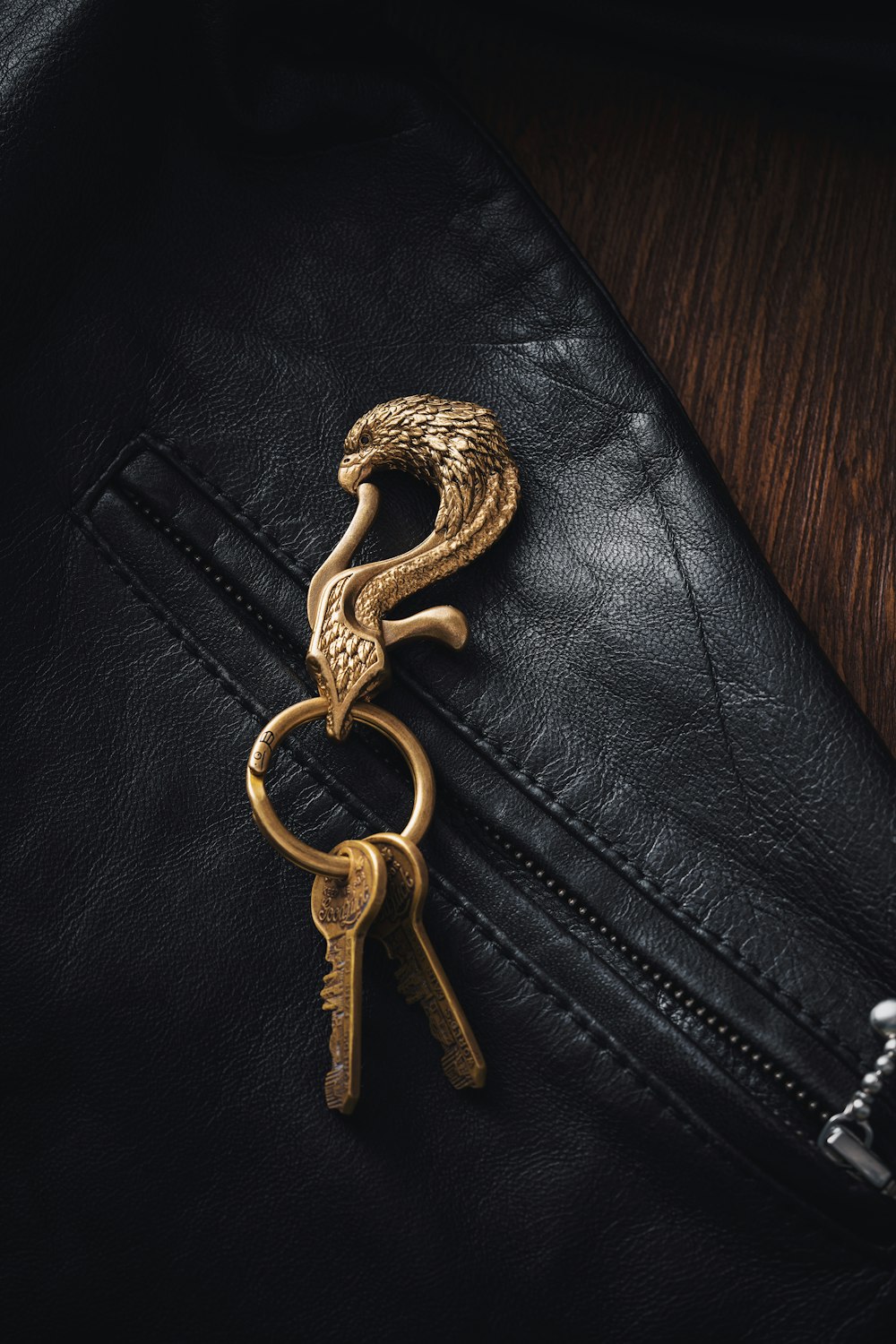 a golden key on top of a black leather jacket