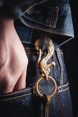 A close-up of a hand reaching into a deep pocket of a durable pair of cargo pants, highlighting the quality stitching.