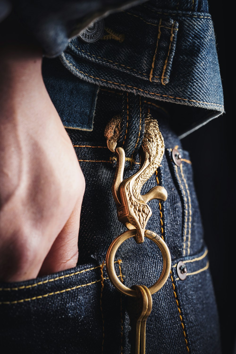 a person with a gold key in their pocket