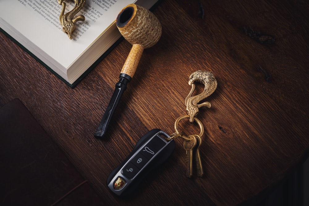 a book, a pen, and a keychain on a table