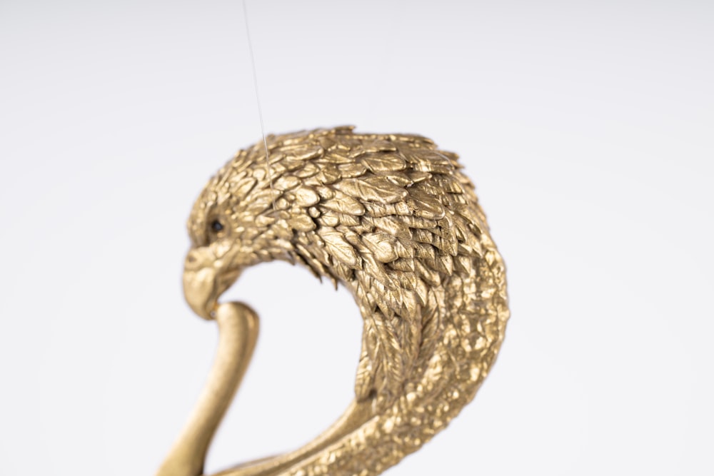 a gold snake sculpture hanging from a hook