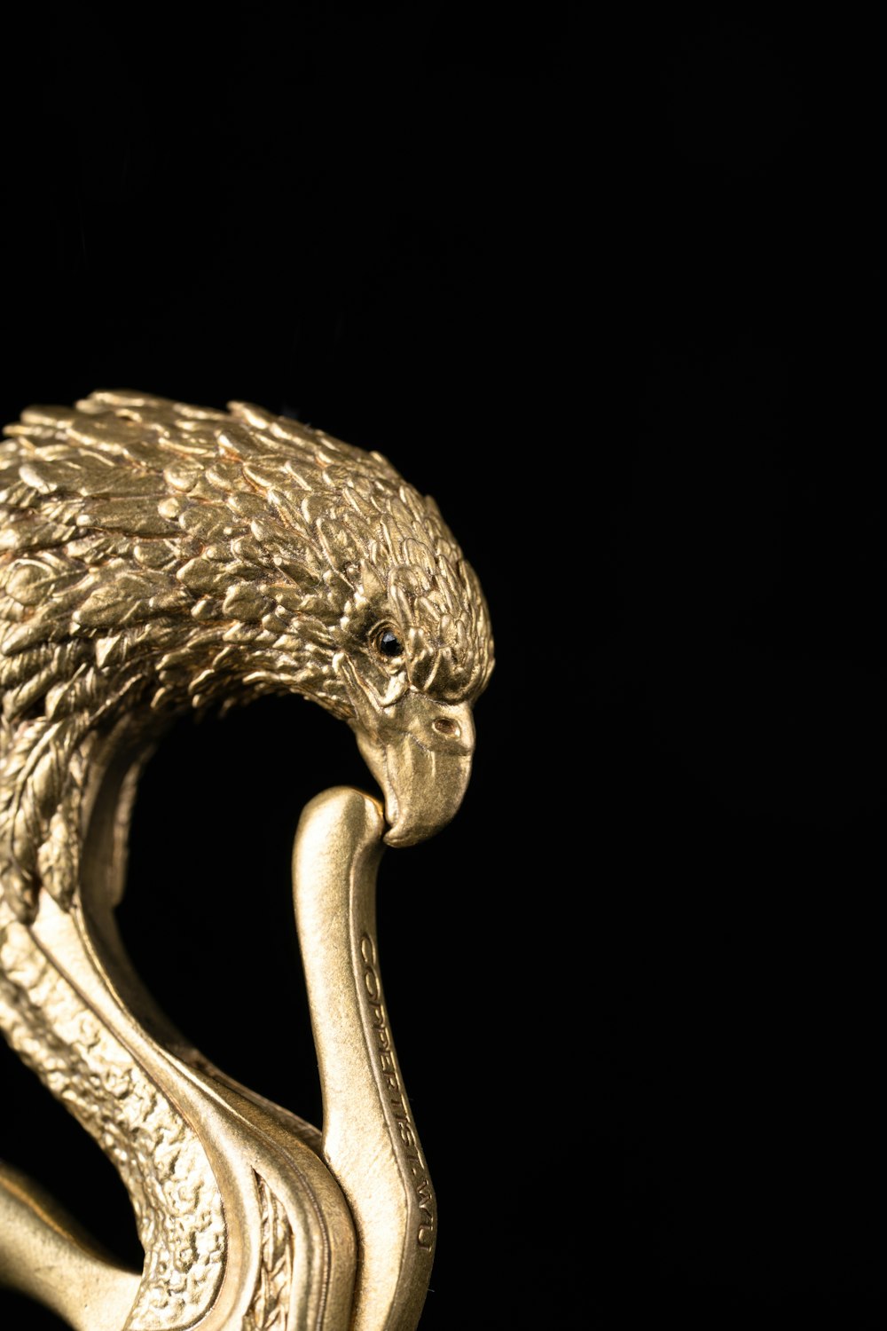 a gold snake ring with a black background