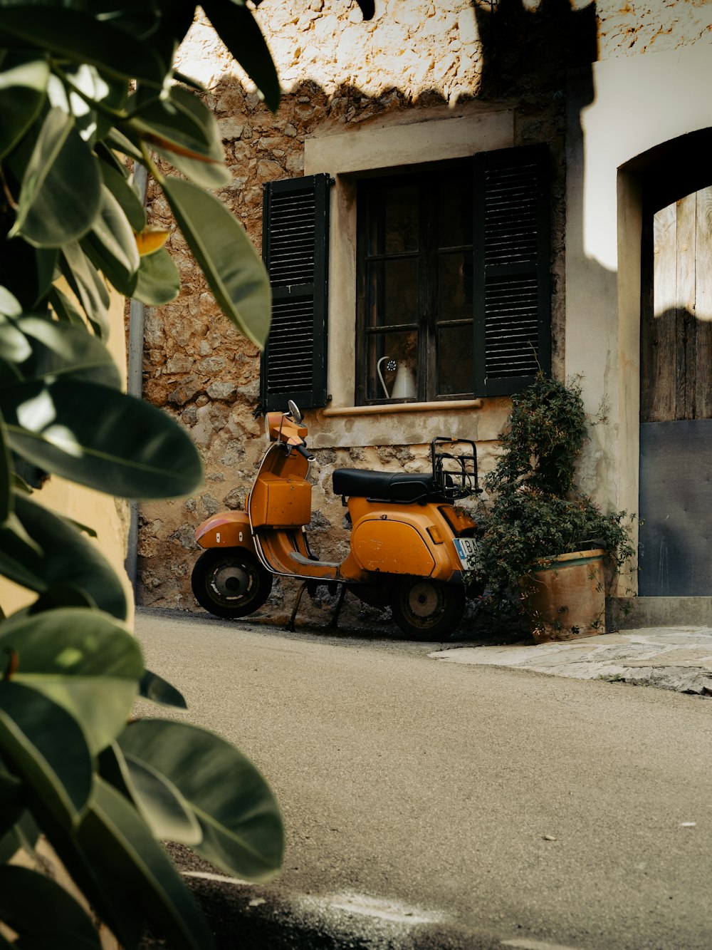 an orange scooter parked in front of a building