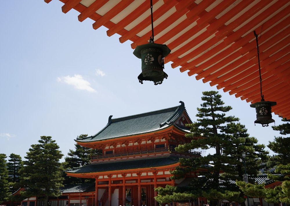 a tall building with a bell hanging from it's side