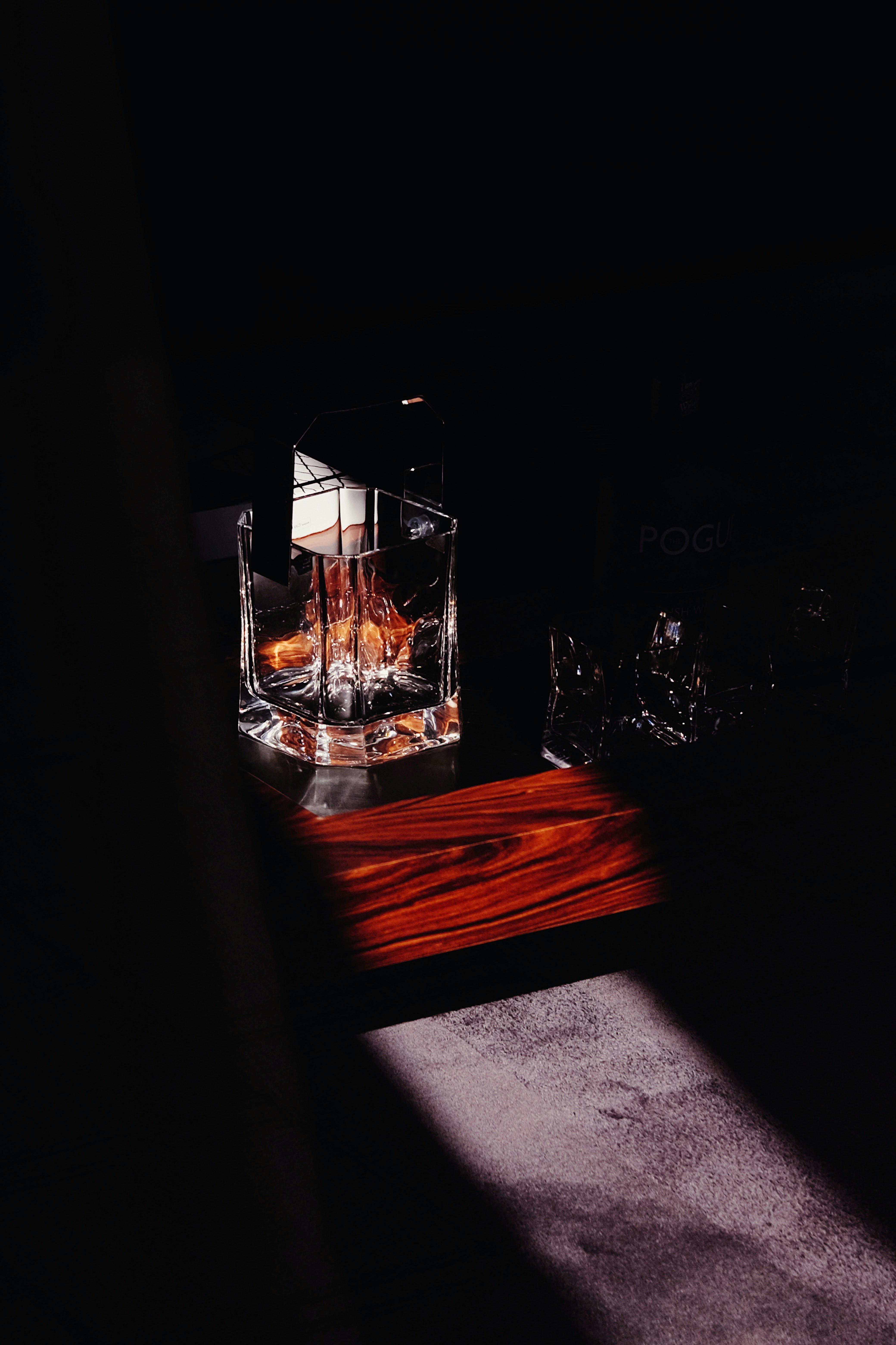 a glass of liquid sitting on top of a wooden table
