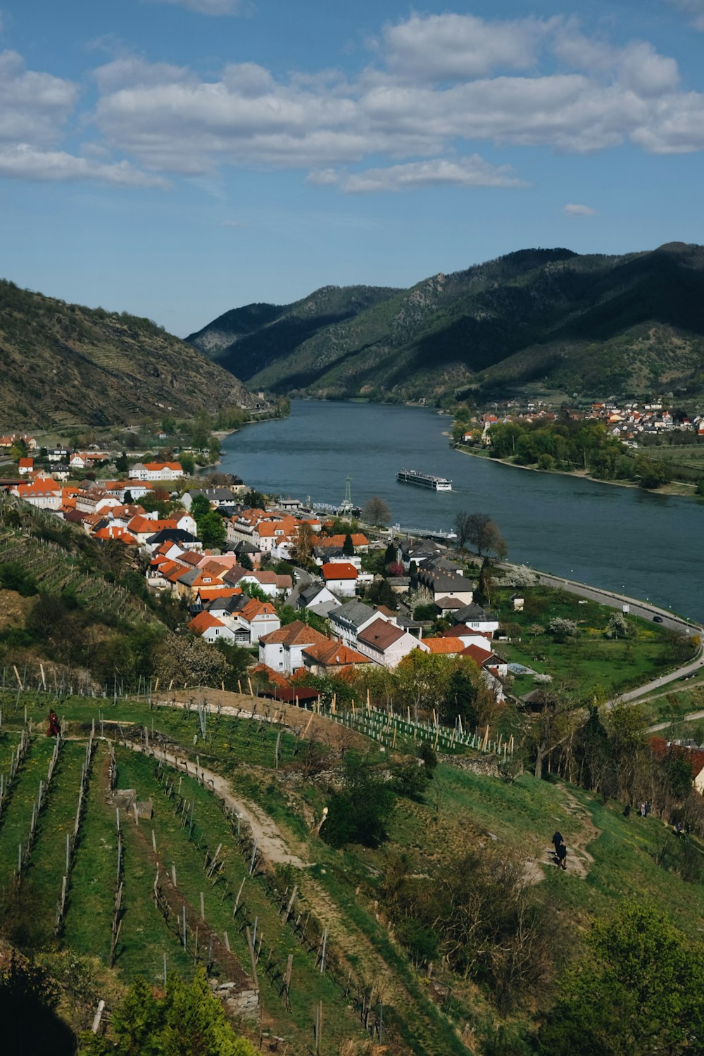 a scenic view of a village and a river