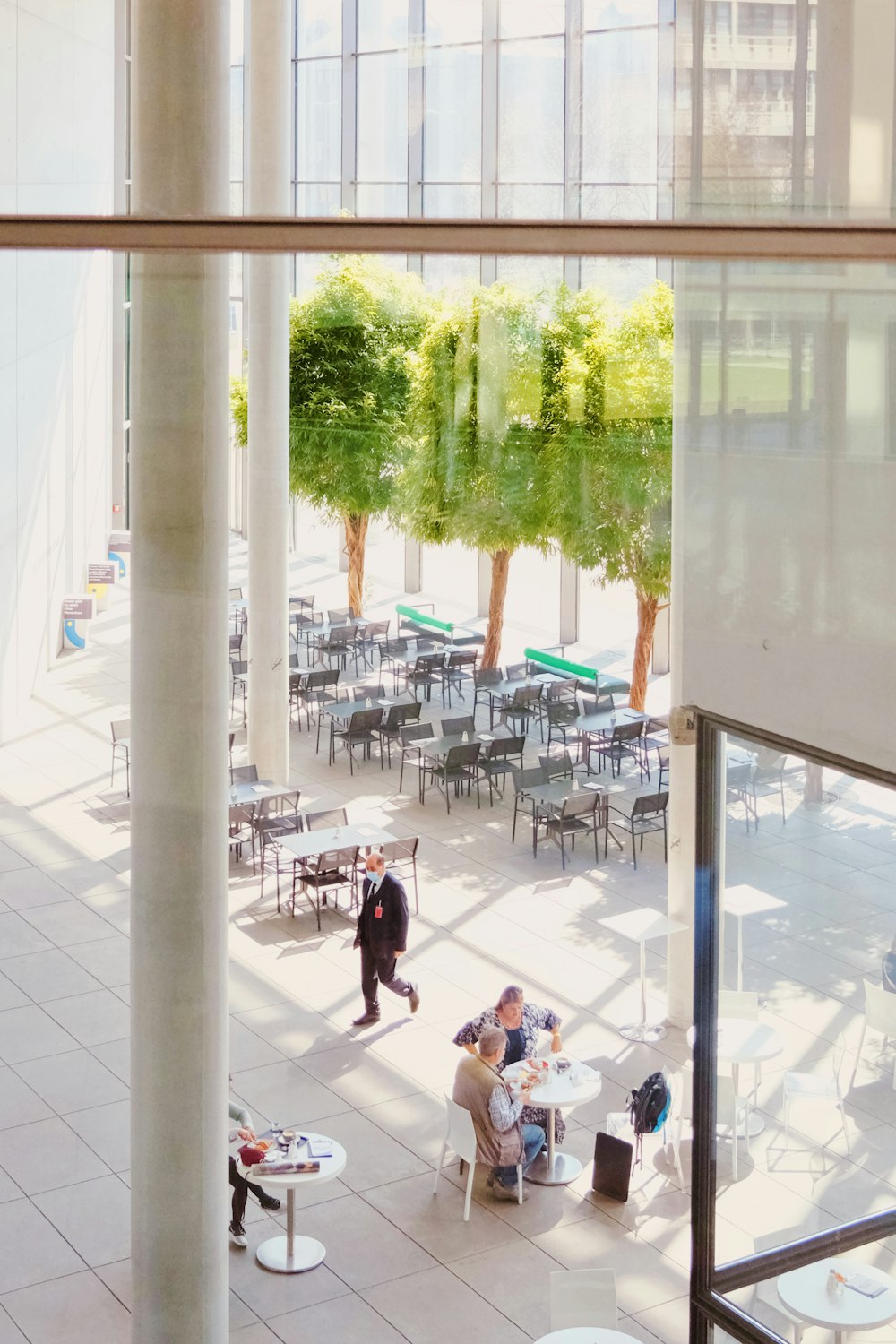 a group of people sitting at tables in a building