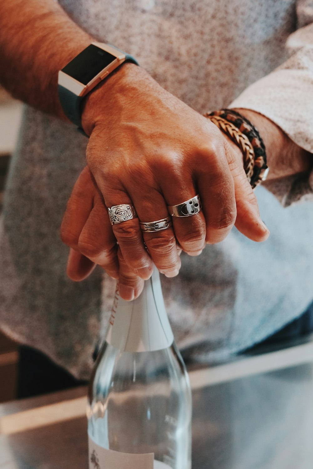 a close up of a person holding a bottle of wine