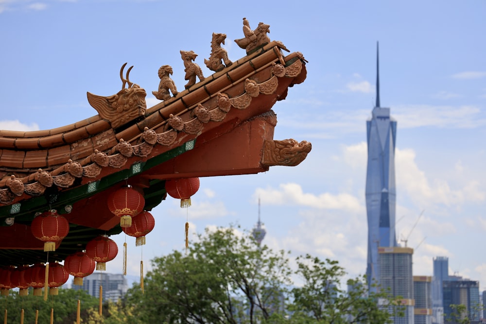 a chinese roof with a tall building in the background