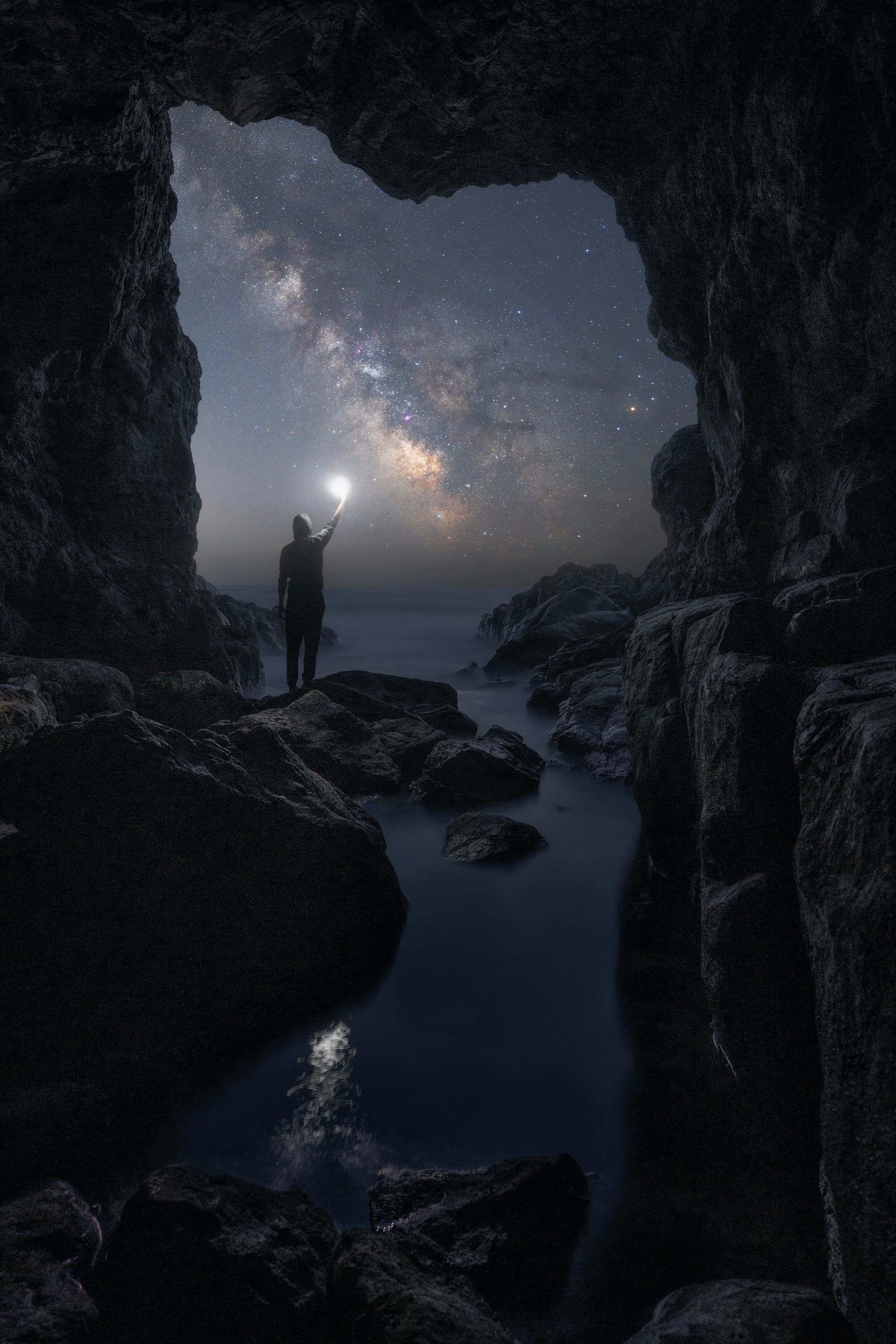 Ein Mann, der in einer Höhle steht und in die Sterne schaut