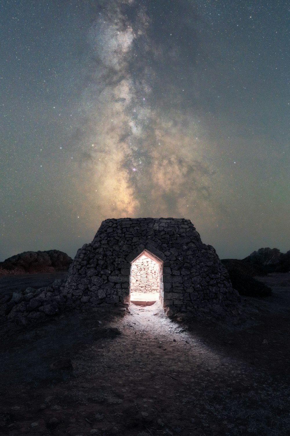 a stone structure with a door in the middle of it