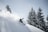 A snowboarder performing tricks in fresh powder, highlighting the excitement of snowboarding.
