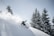 A snowboarder performing tricks in fresh powder, highlighting the excitement of snowboarding.
