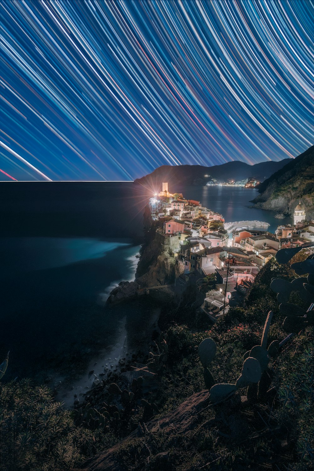 a long exposure of the night sky over a town