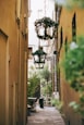 a narrow alley way with a wreath hanging from the ceiling