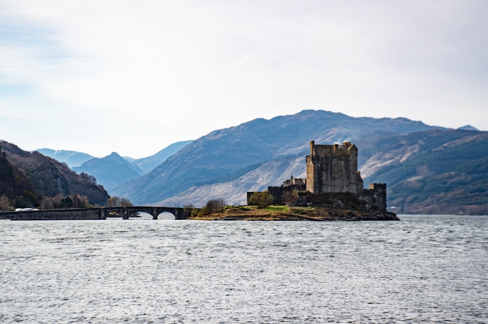 a castle sitting on a small island in the middle of a lake