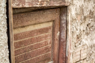 Close-up of a handcrafted rustic wooden door with natural grain textures.