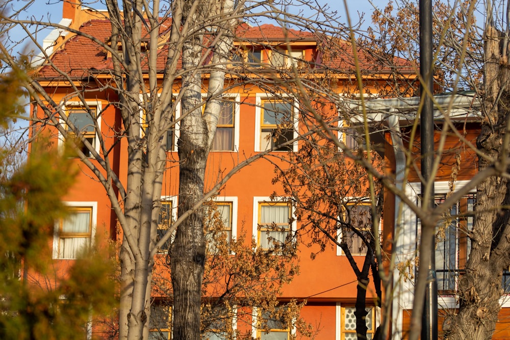 an orange building with a clock on the front of it