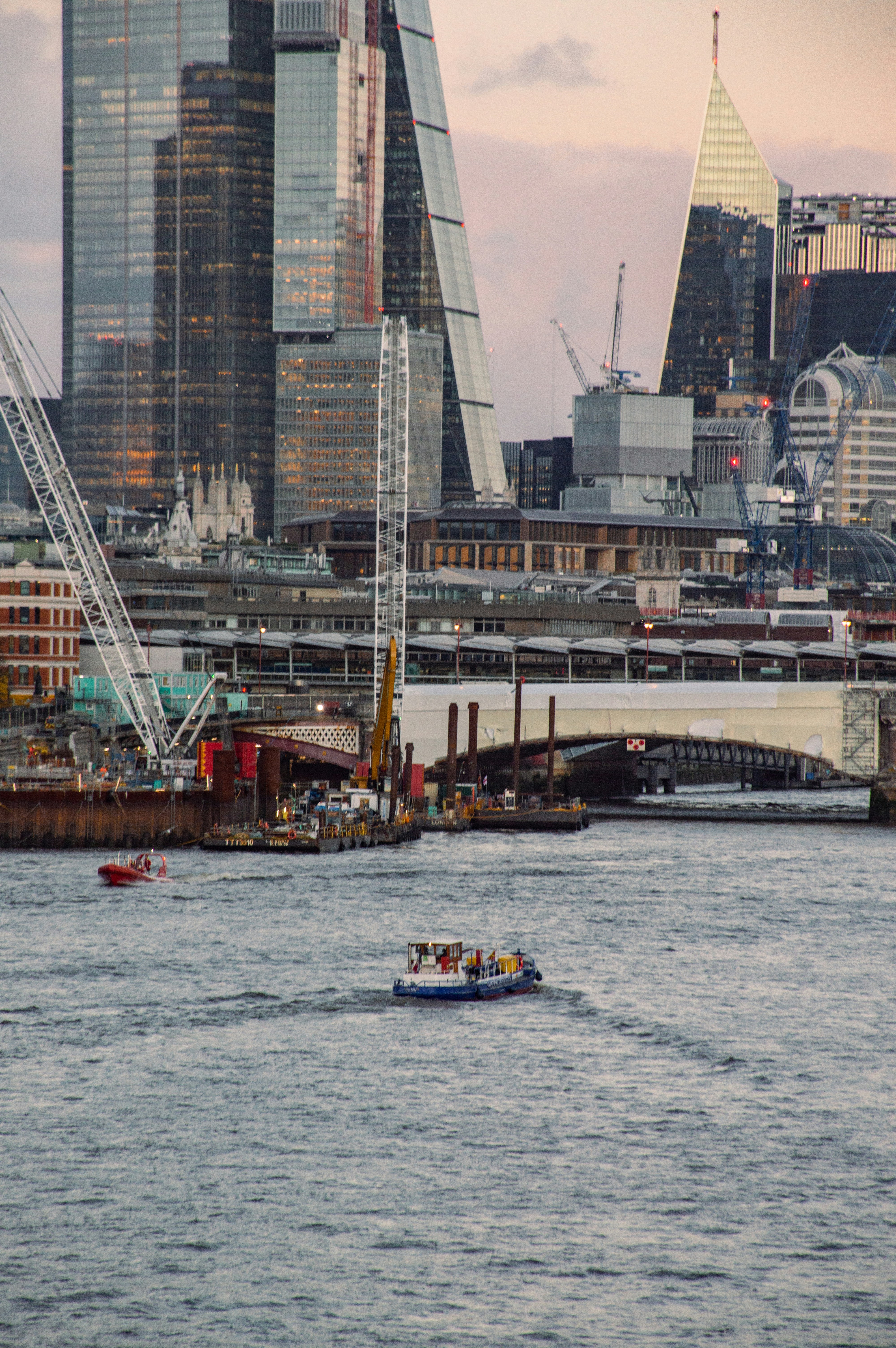 a boat in a body of water with a city in the background