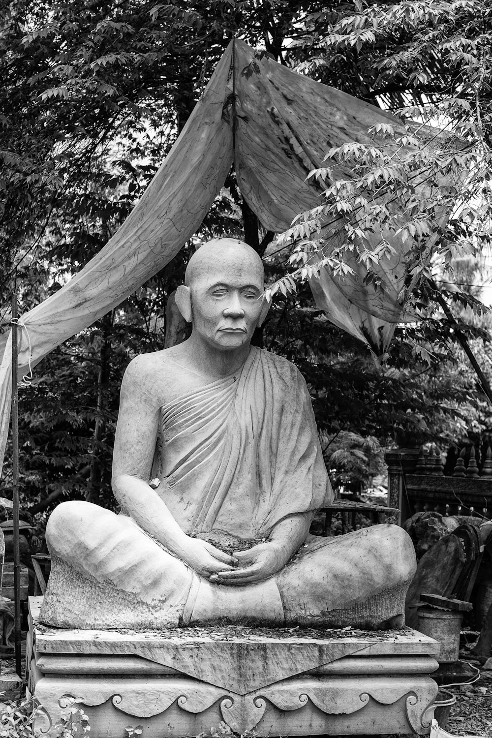 a black and white photo of a buddha statue