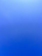 an airplane flying in the sky with a blue background