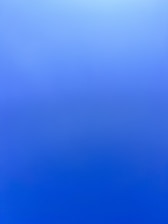 an airplane flying in the sky with a blue background