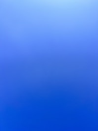 an airplane flying in the sky with a blue background