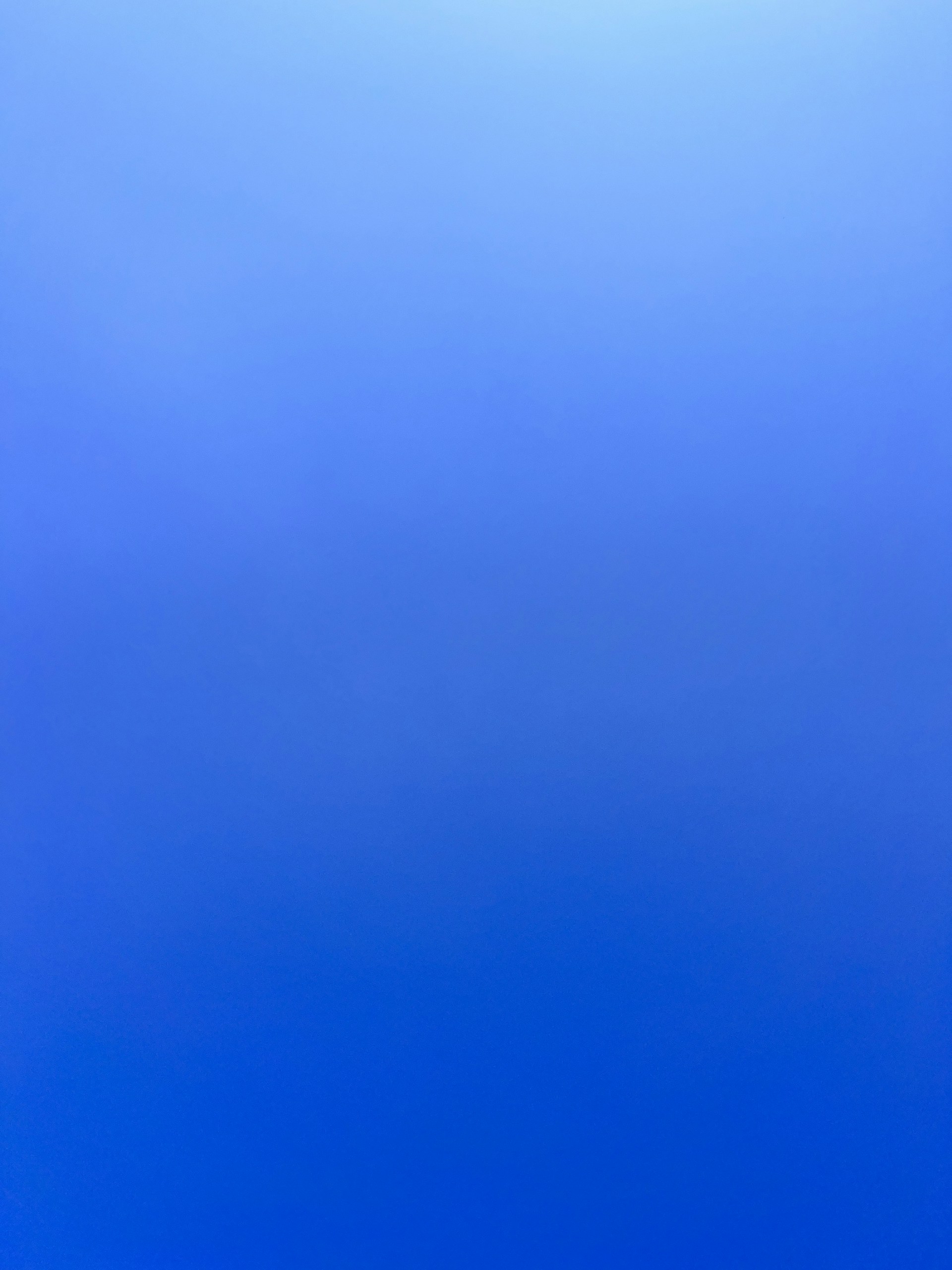 an airplane flying in the sky with a blue background