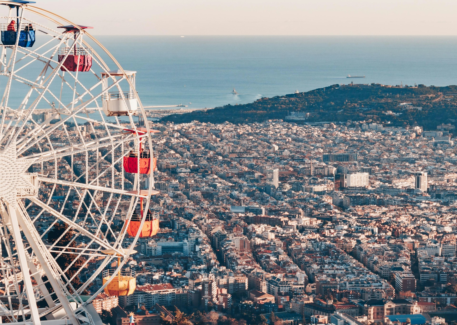 a ferris wheel in front of a cityscape