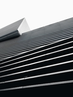 Minimalist architectural blueprint with black and white geometric lines forming a diamond shape.