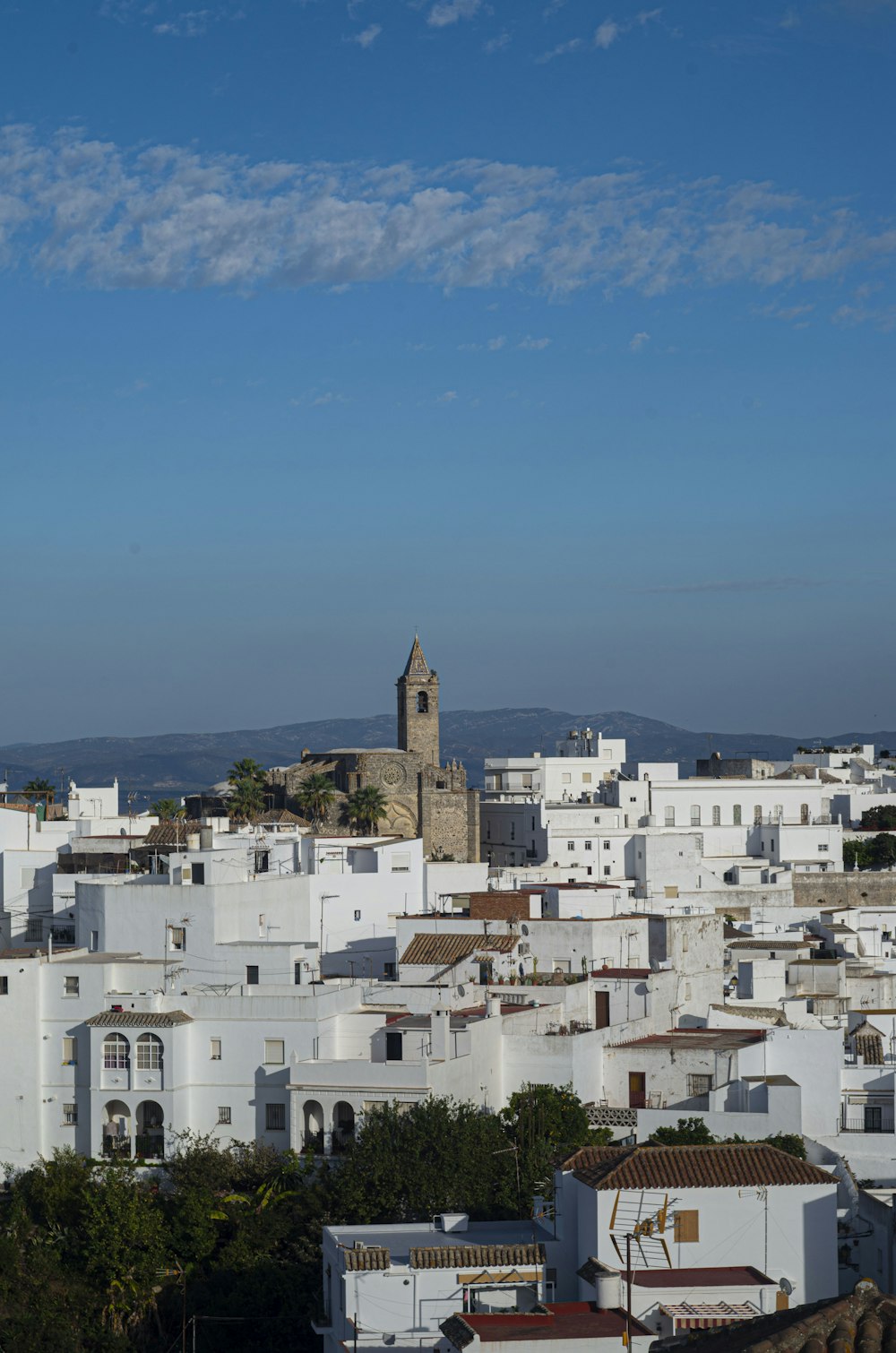 a city with white buildings and a clock tower
