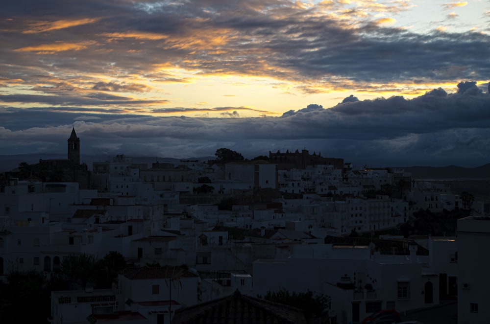 a view of a city with a clock tower in the distance