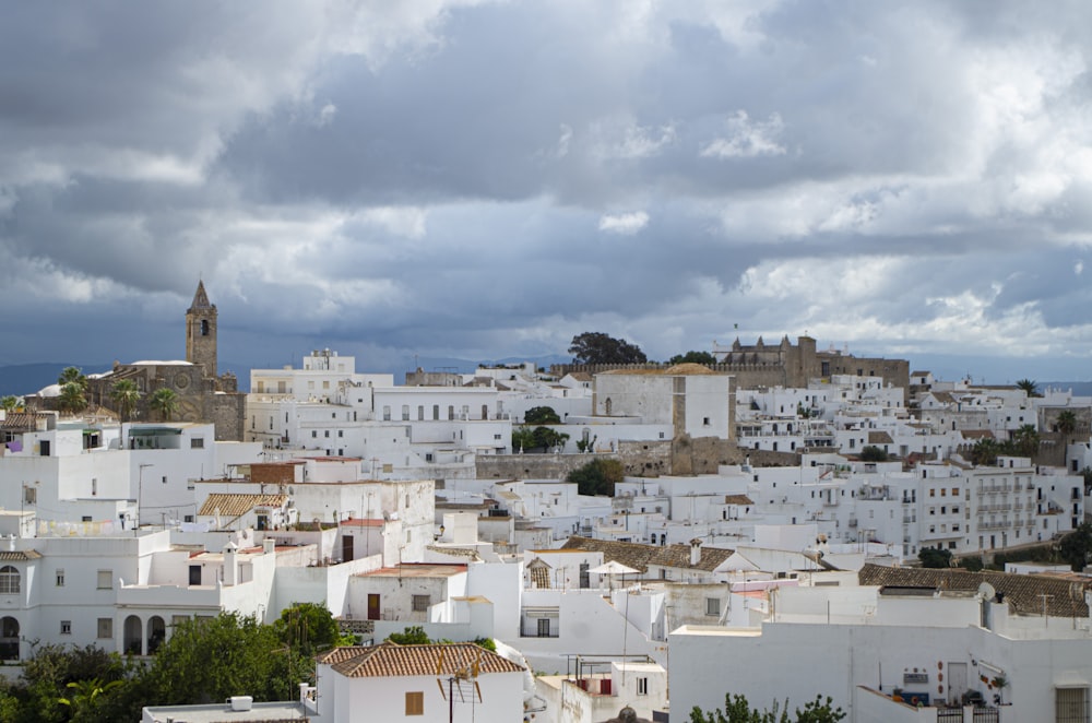 a view of a city with white buildings under a cloudy sky