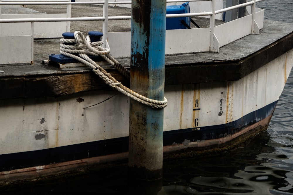 a white and blue boat docked at a dock