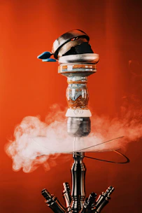 Close-up of a beautifully crafted hookah with golden accents and rich sheesha flavors displayed.