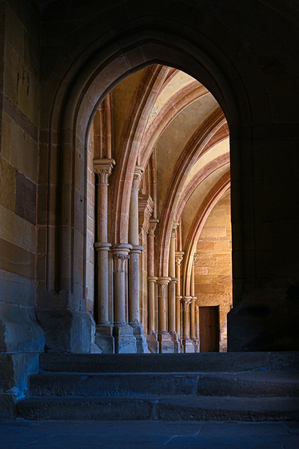 an archway in a building with stone steps