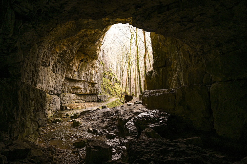 a cave with a light at the end of it