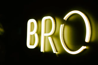 A bright, bold logo of Bad Boy Reviews glowing against a dark background.